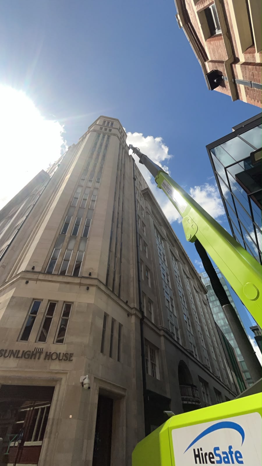 A&D Electrical Sunlight House lighting project — working at height from an access platform at the building entrance