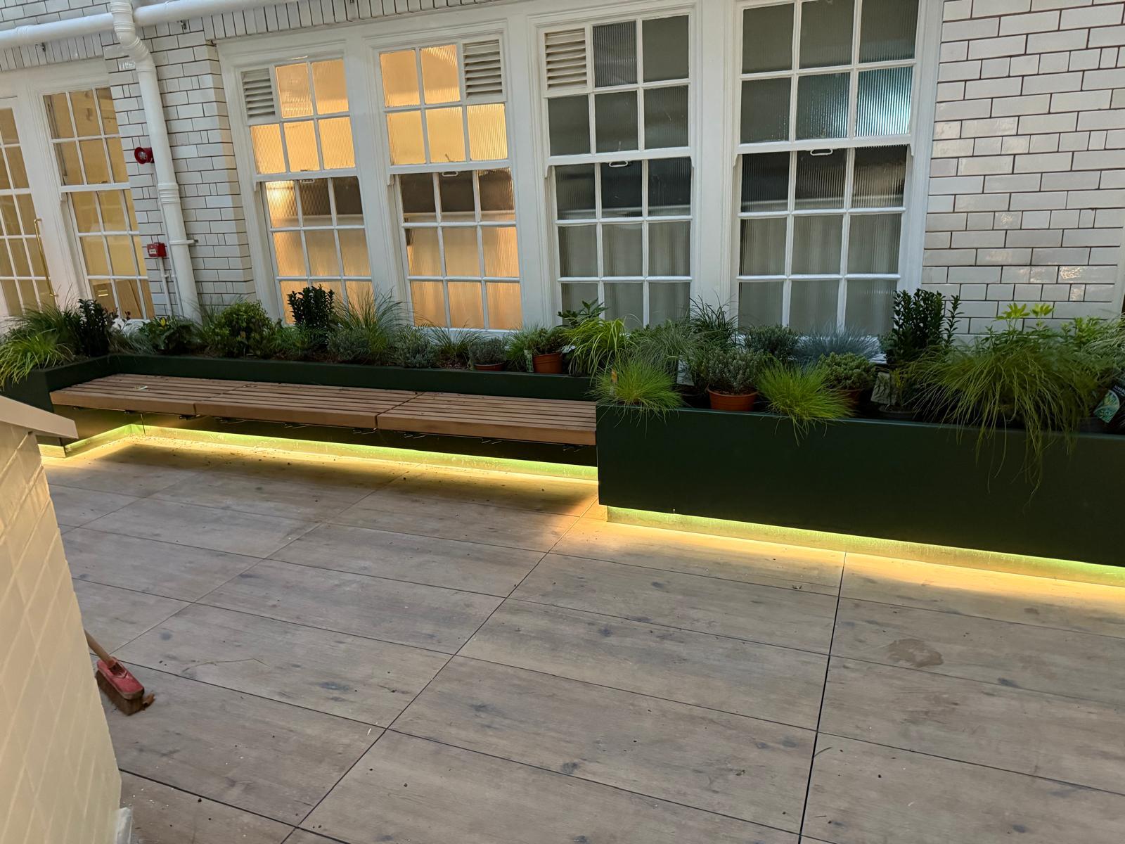 A&D Electrical Sunlight House lighting project — courtyard seating with warm white LED strip lighting